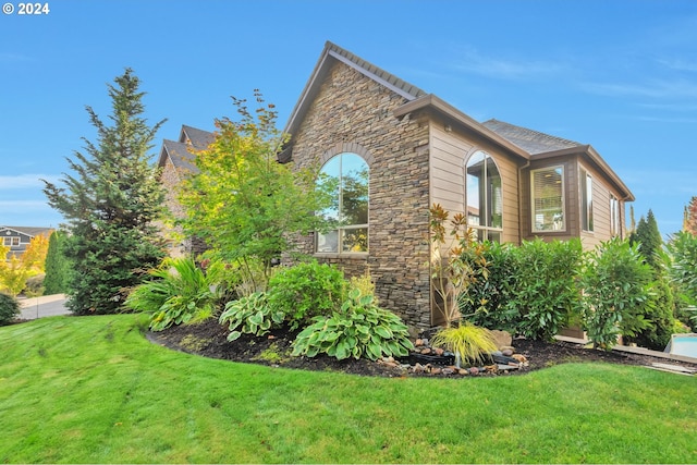 view of home's exterior with a lawn