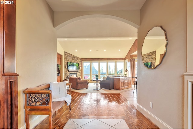 interior space with light hardwood / wood-style floors and lofted ceiling