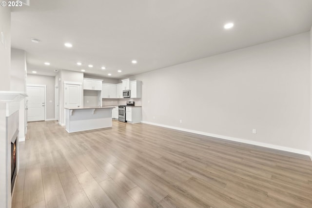 unfurnished living room featuring light wood-type flooring