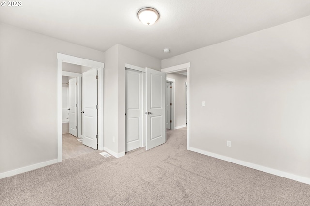 unfurnished bedroom featuring light colored carpet