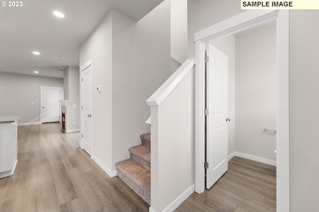 stairs featuring hardwood / wood-style flooring