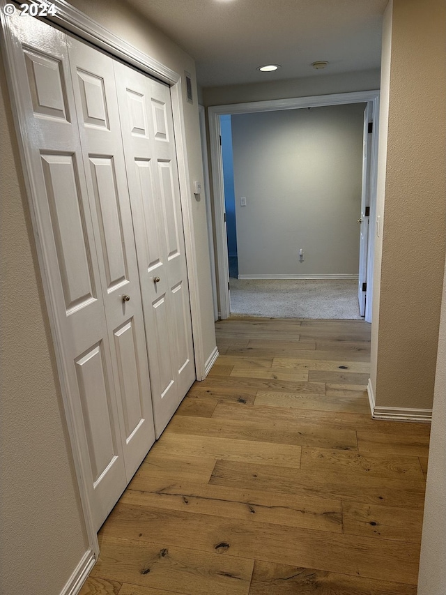 hall with light hardwood / wood-style floors