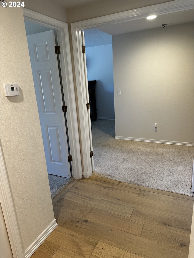 corridor with light hardwood / wood-style flooring