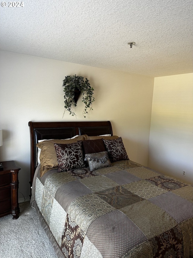 carpeted bedroom with a textured ceiling