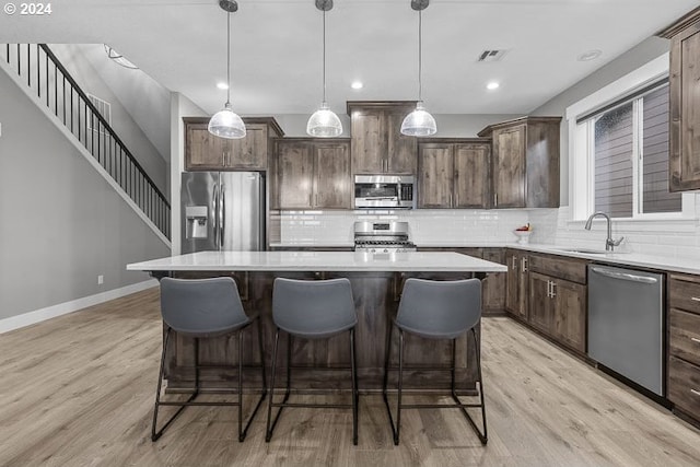 kitchen featuring pendant lighting, stainless steel appliances, and a kitchen island