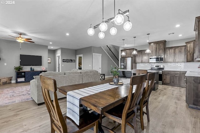 dining space with ceiling fan and light hardwood / wood-style floors