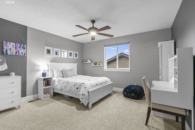 bedroom featuring carpet flooring, a textured ceiling, and ceiling fan