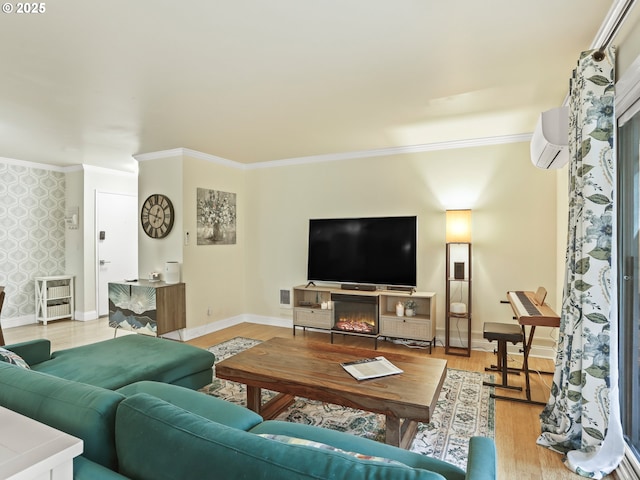 living room with light wood-style floors, ornamental molding, baseboards, and a wall mounted AC