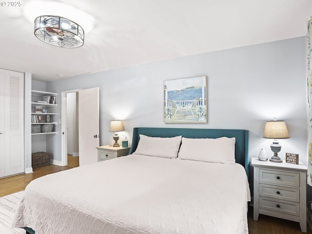 bedroom featuring dark wood-style floors and a closet