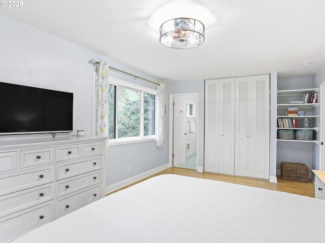 unfurnished bedroom with light wood-style floors, a closet, and baseboards