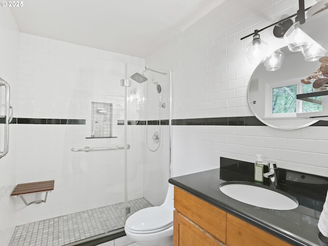 bathroom with toilet, a shower stall, backsplash, and vanity