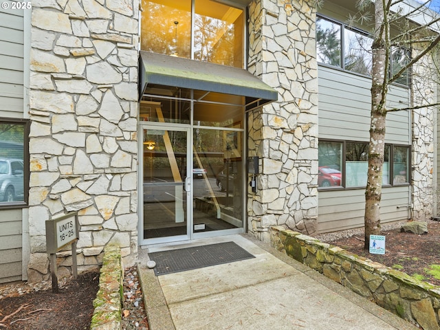 doorway to property featuring stone siding