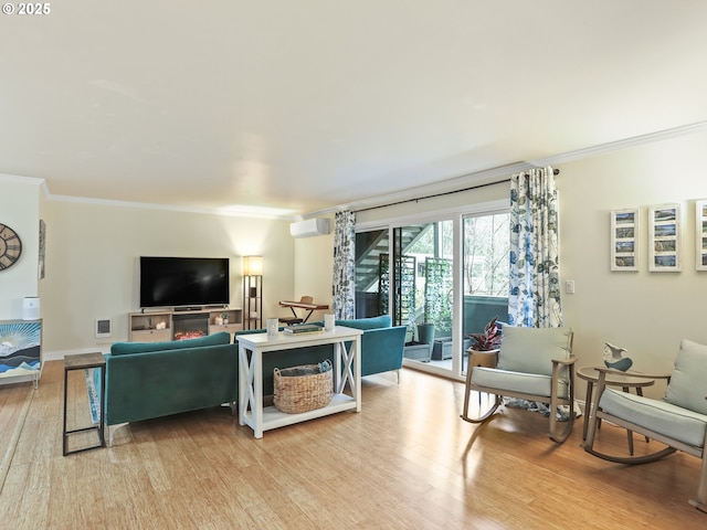 living room with visible vents, crown molding, light wood-style flooring, and baseboards