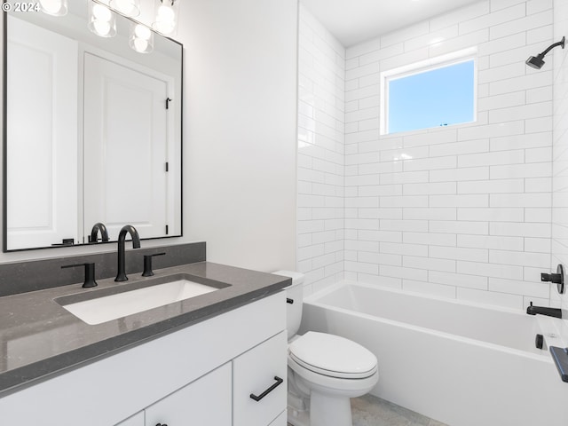 full bathroom featuring toilet, vanity, and tiled shower / bath