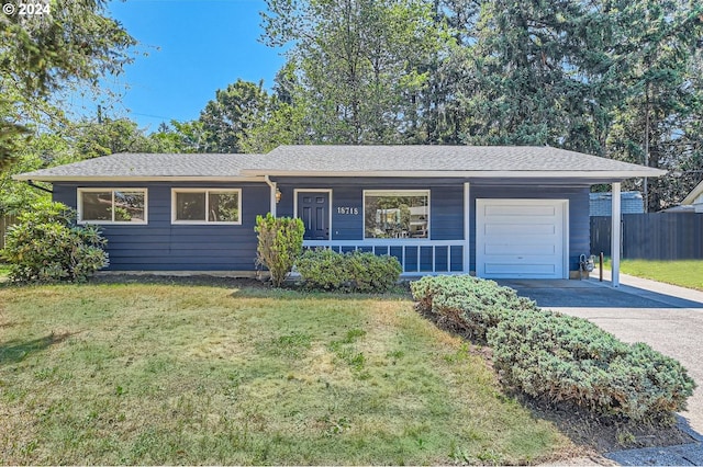 single story home featuring a garage and a front lawn