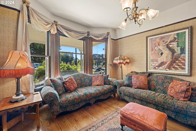 living room with wood-type flooring and a notable chandelier