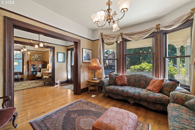 living room featuring wood-type flooring and a notable chandelier