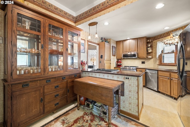 kitchen with backsplash, decorative light fixtures, a kitchen island, and stainless steel appliances