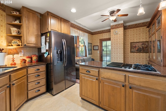 kitchen featuring decorative backsplash, ceiling fan, and appliances with stainless steel finishes