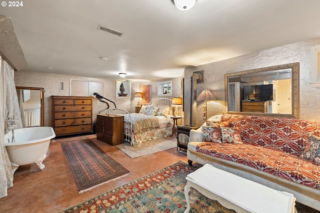 bedroom featuring concrete flooring