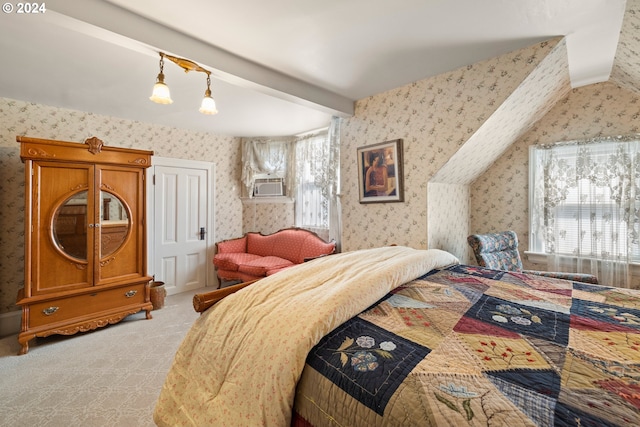 bedroom with beam ceiling and light colored carpet