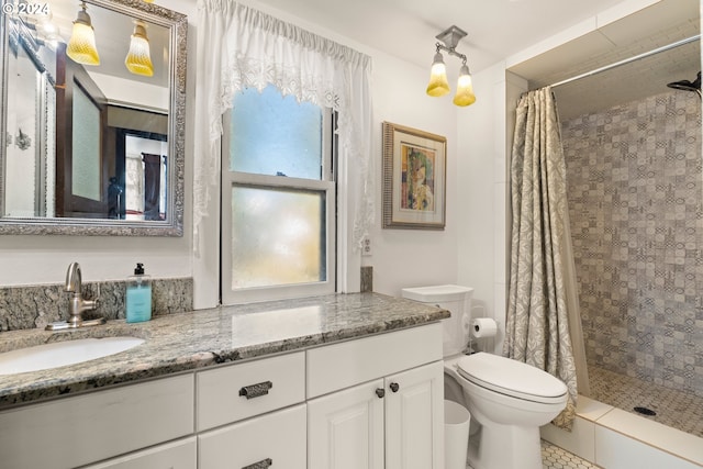 bathroom with tile patterned flooring, vanity, toilet, and walk in shower