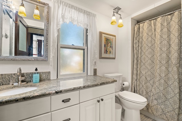 bathroom featuring tile patterned flooring, vanity, and toilet