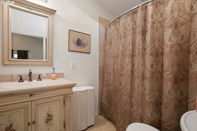 bathroom featuring toilet, vanity, tile patterned floors, and lofted ceiling