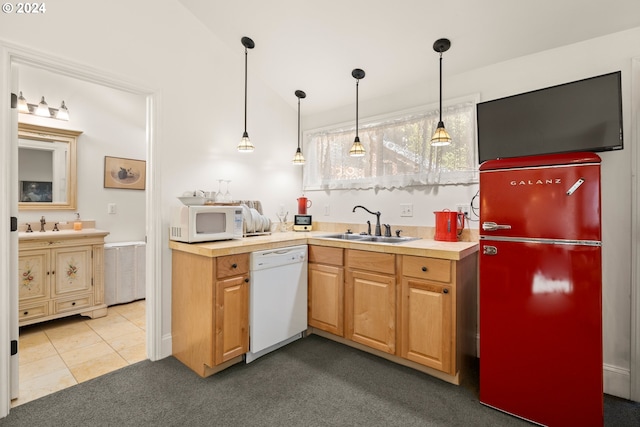 kitchen with white appliances, decorative light fixtures, vaulted ceiling, and sink