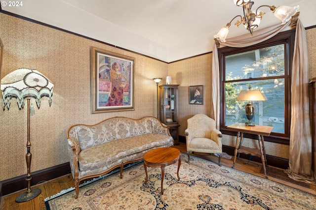 sitting room with a chandelier and hardwood / wood-style flooring