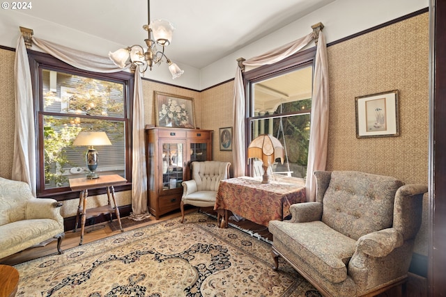 sitting room featuring hardwood / wood-style floors and a notable chandelier