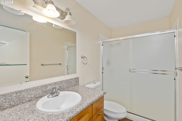 bathroom with vanity, toilet, and walk in shower