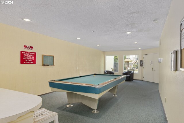 playroom with carpet floors, a textured ceiling, and pool table