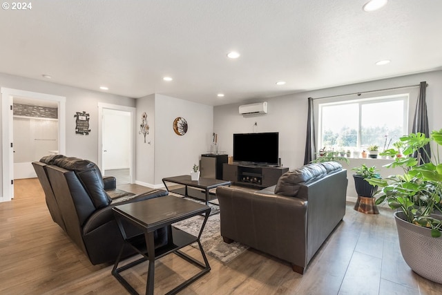 living room with wood-type flooring and a wall mounted AC