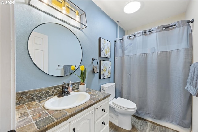 bathroom with vanity, toilet, hardwood / wood-style flooring, and a shower with curtain