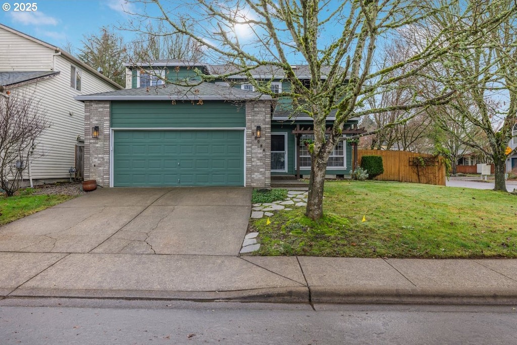 view of front facade with a garage and a front lawn