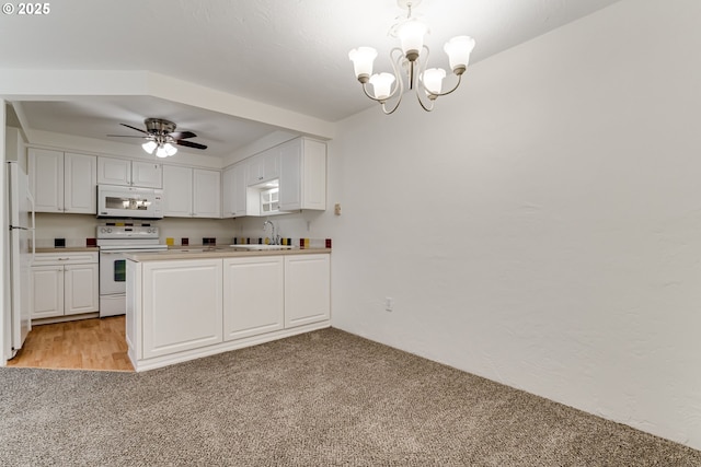 kitchen featuring white cabinetry, white appliances, sink, and light carpet