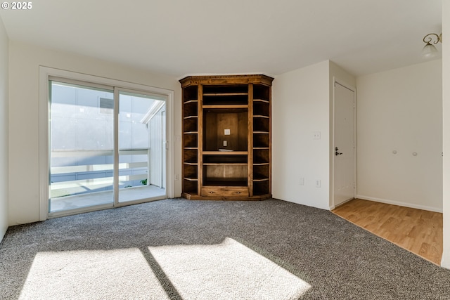 unfurnished living room with carpet flooring and a wealth of natural light