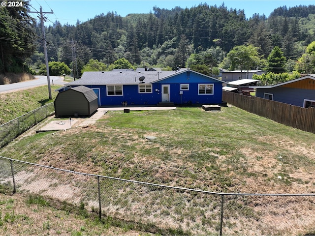 rear view of property featuring a patio and a lawn