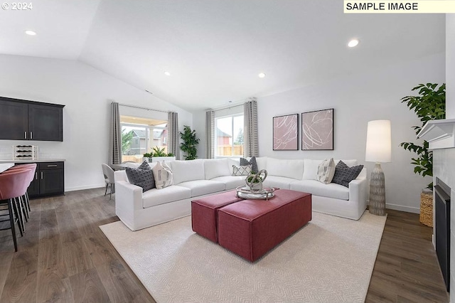 living room with a fireplace, dark wood-type flooring, and vaulted ceiling