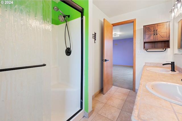 bathroom featuring vanity, tile patterned floors, and walk in shower