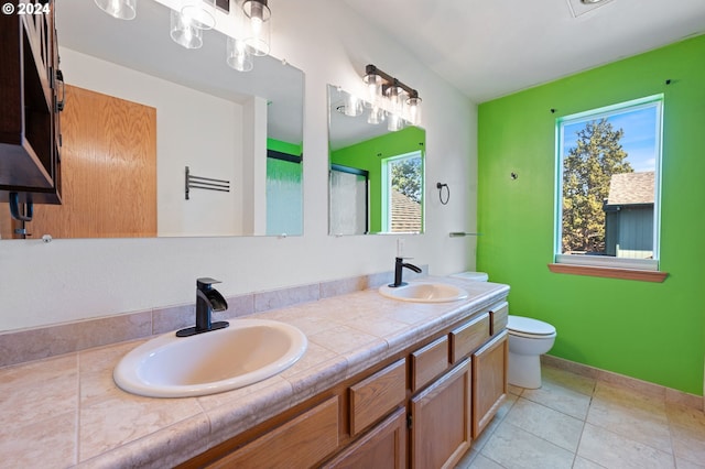 bathroom featuring tile patterned flooring, vanity, and toilet