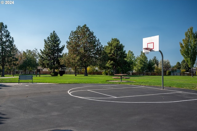 view of basketball court featuring a yard