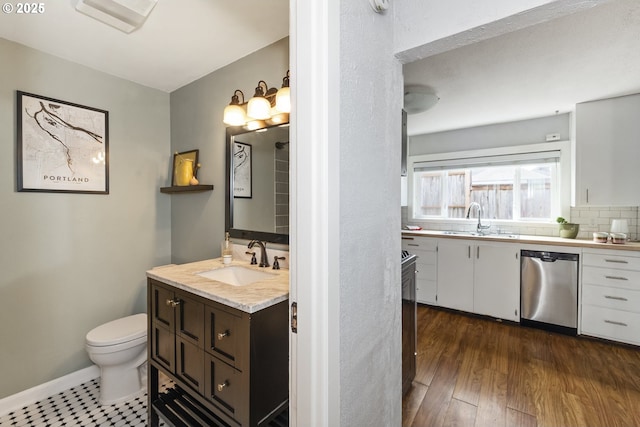 4524 NE 41st Ave, Portland, OR 97211 - bathroom featuring vanity, tasteful backsplash, and wood finished floors