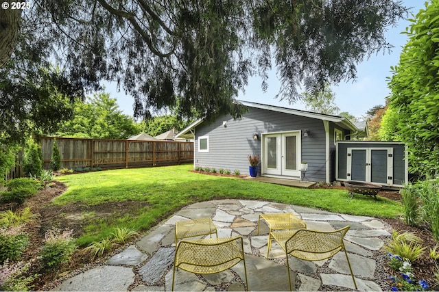 4524 NE 41st Ave, Portland, OR 97211 - view of yard featuring french doors, an outdoor fire pit, a patio area, and an outdoor structure