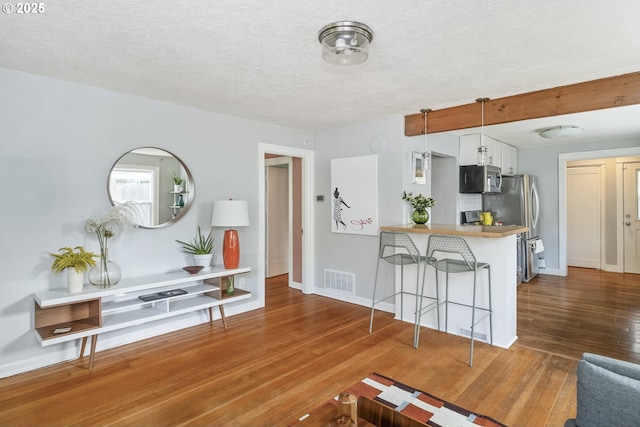 4524 NE 41st Ave, Portland, OR 97211 - living area with wood finished floors, a textured ceiling, and baseboards