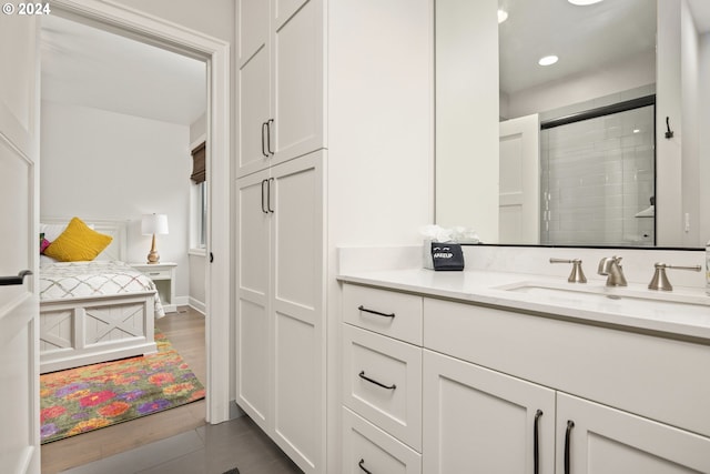 bathroom featuring vanity, a shower with shower door, and hardwood / wood-style floors