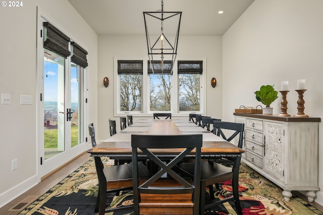 dining area with recessed lighting, a healthy amount of sunlight, baseboards, and wood finished floors