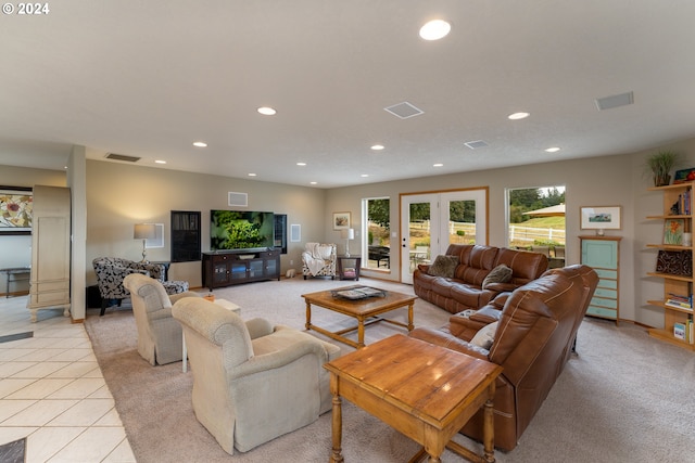 living room featuring light tile patterned floors and french doors