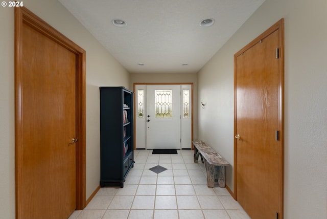 entrance foyer featuring light tile patterned floors, recessed lighting, and baseboards